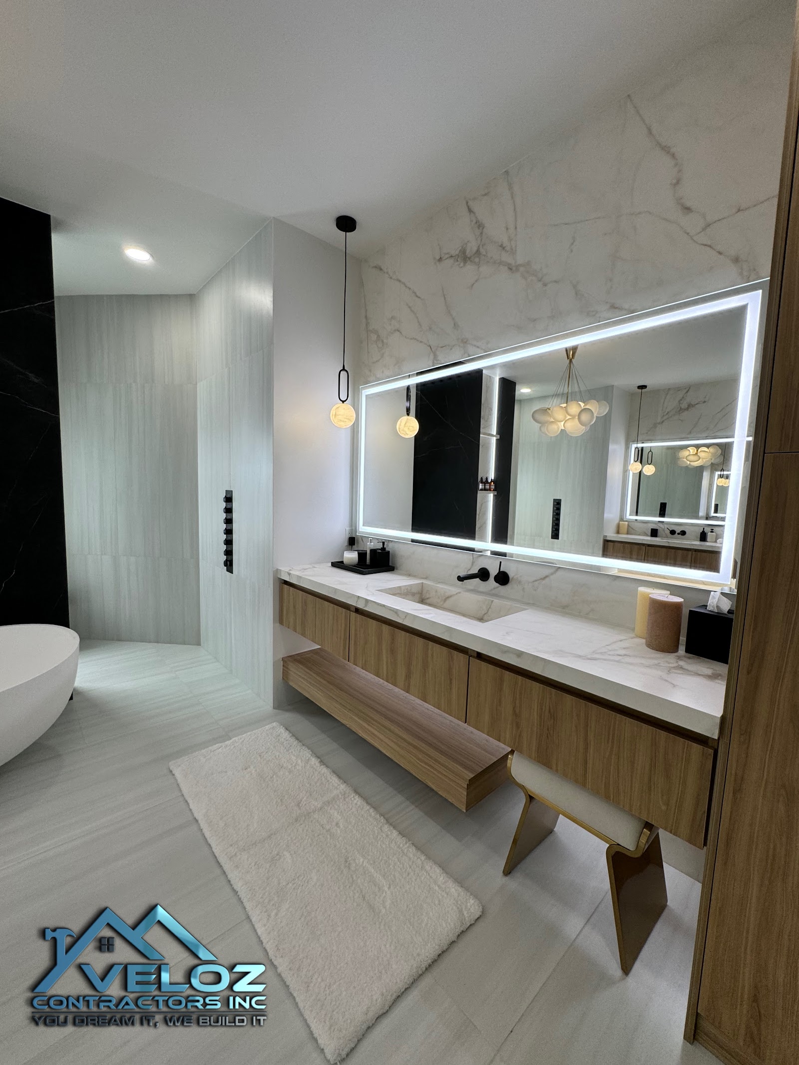 Floating vanity with marble countertop and LED-backlit mirror